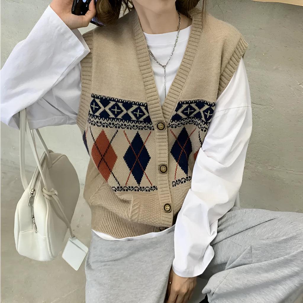 Khaki diamond plaid sleeveless cardigan top laid flat, showing loose fit and sleeveless armholes.