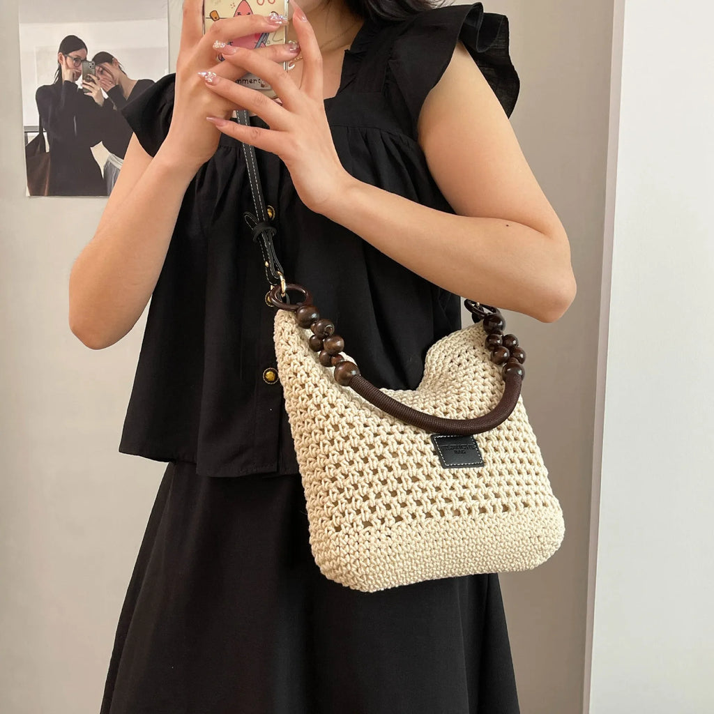 Knitted tote beach bag with contrast stitching showing crossbody strap and zip compartment
