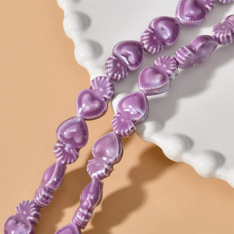 Ceramic heart torch beads in various colours for jewellery making, approximately 10mm by 15mm with straight hole
