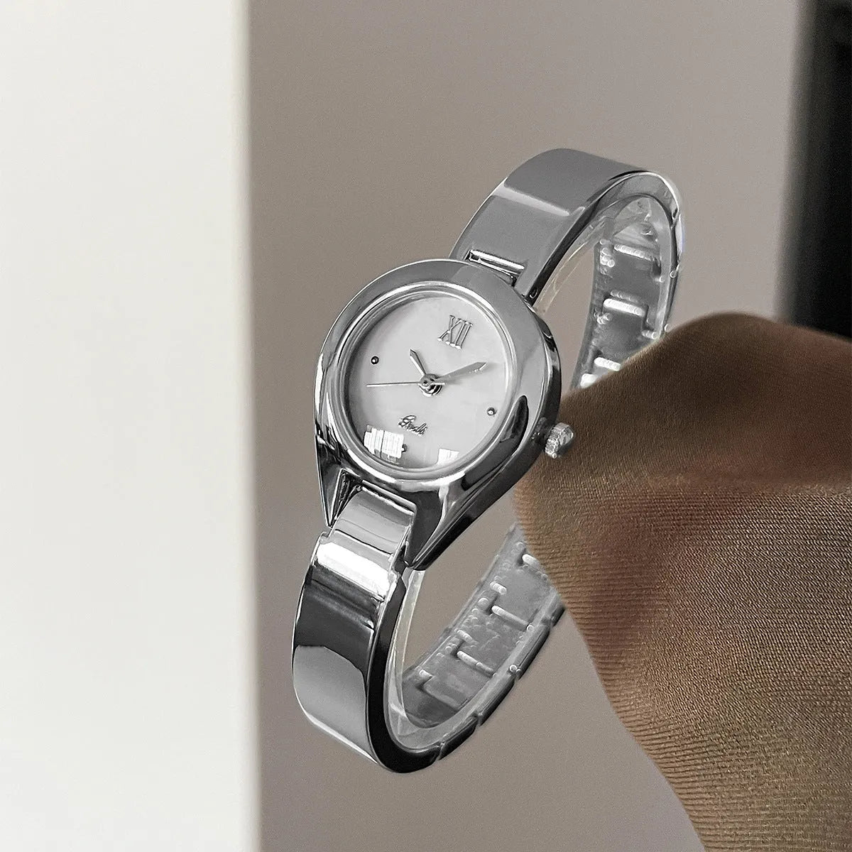 Women's quartz watch with 30mm white shell dial, silver hands, and white strap on display