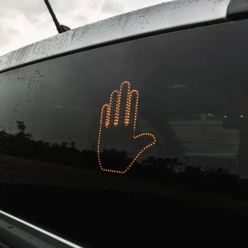 Black plastic car gesture light with LED illuminated hand gesture, remote control, and 3M Velcro mounting