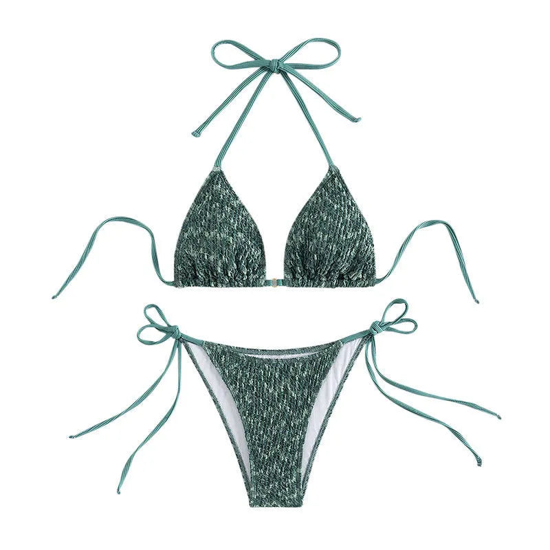 Green and pink women's backless halter swimsuit top and shorts set on a white background