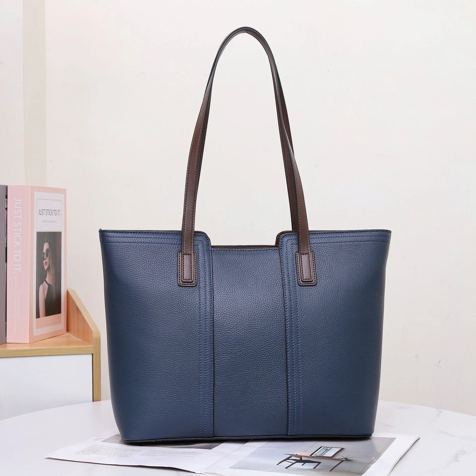 Women's genuine leather shoulder bag in khaki colour showing box-type design and organised interior compartments