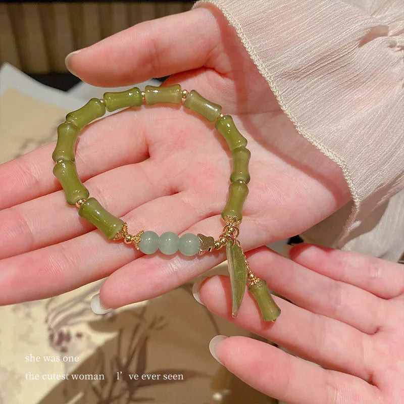 Chinese style glass bracelet with bamboo joint details in a red Lvzhu Duobao design.