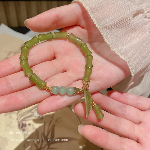 Chinese style glass bracelet with bamboo joint details in a red Lvzhu Duobao design.
