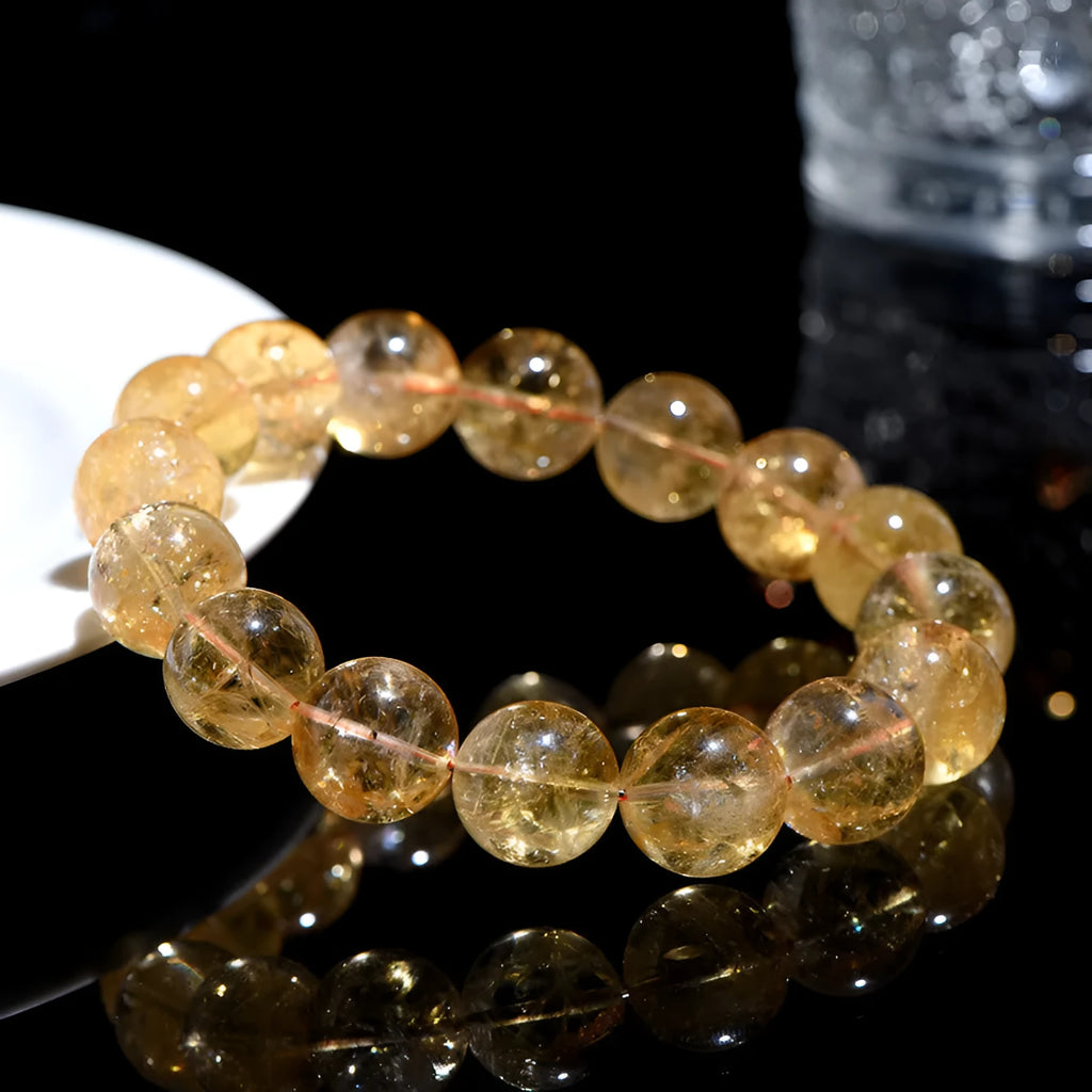 Natural yellow Asestelle citrine bracelet with hand-ground geometry beads on a wrist.