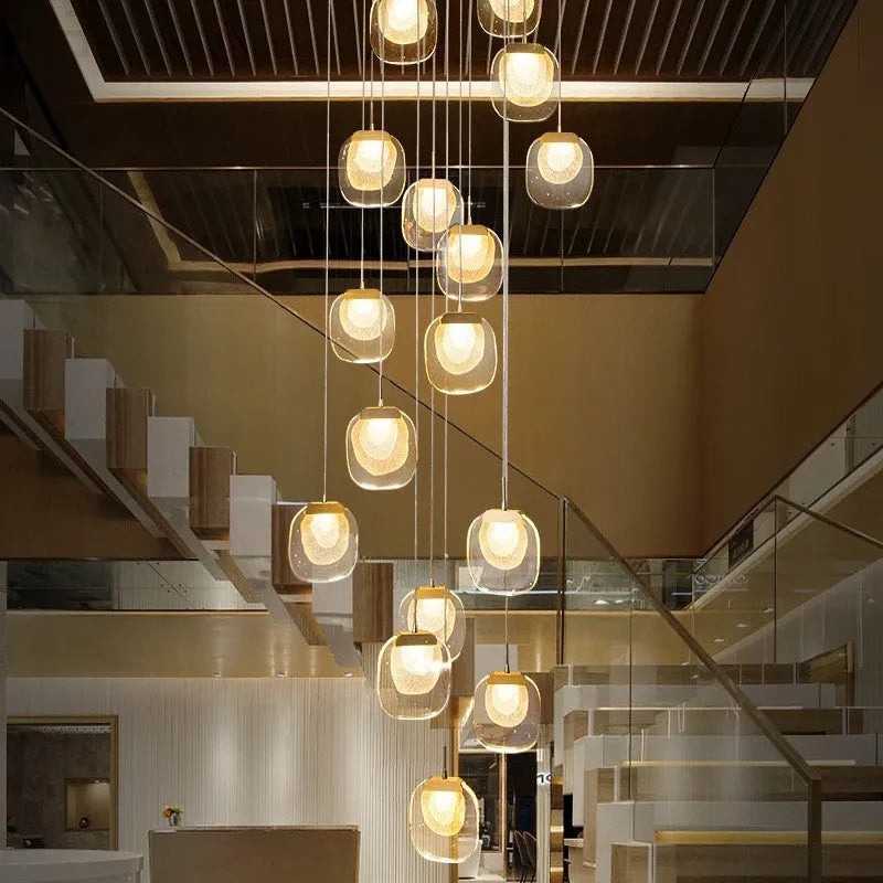Postmodern crystal chandelier with six gold heads, stainless steel chassis, and adjustable cable on a ceiling