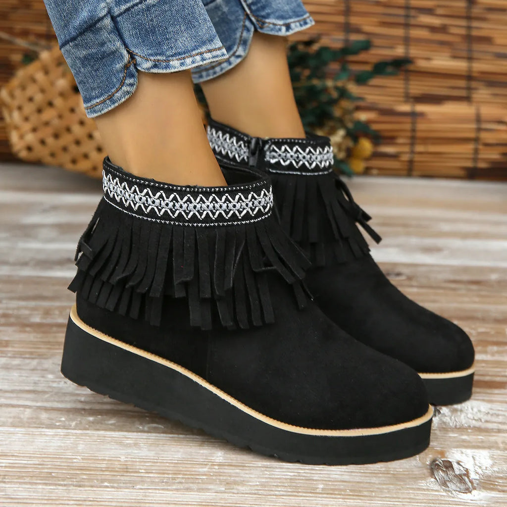Women's dark brown suede wedge bootie with side zip, tassel detail, and thick rubber sole