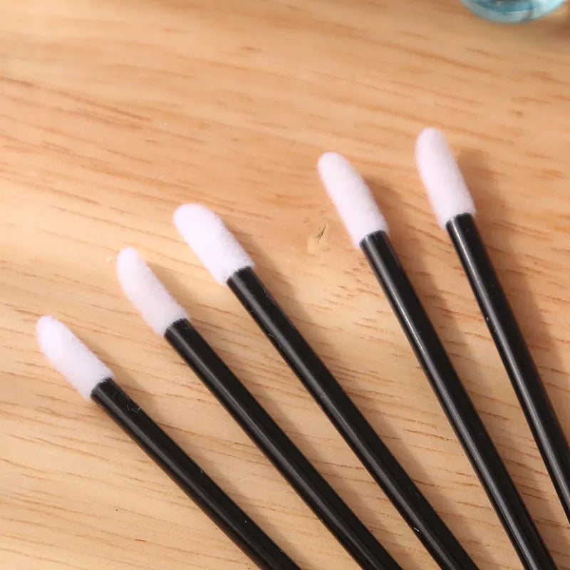 Disposable lip brushes with coloured handles and flocked brush heads for lip makeup application