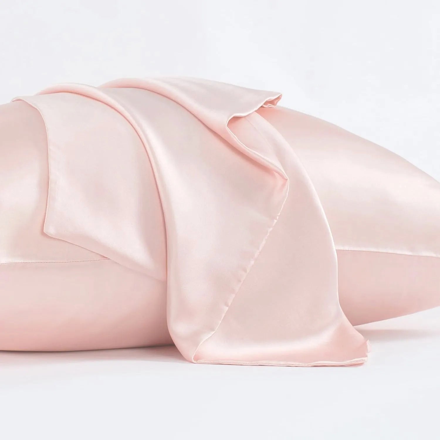 Solid colour mulberry silk envelope pillowcase in dark grey on a bed.