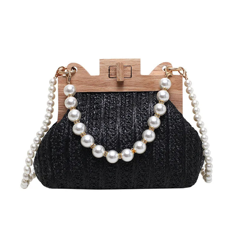Women's woven straw shoulder bag with pearl chain strap in horizontal square shape showing sandwich pocket detail.