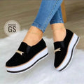 Women's black slip-on flat platform sneakers with round toe and low heel