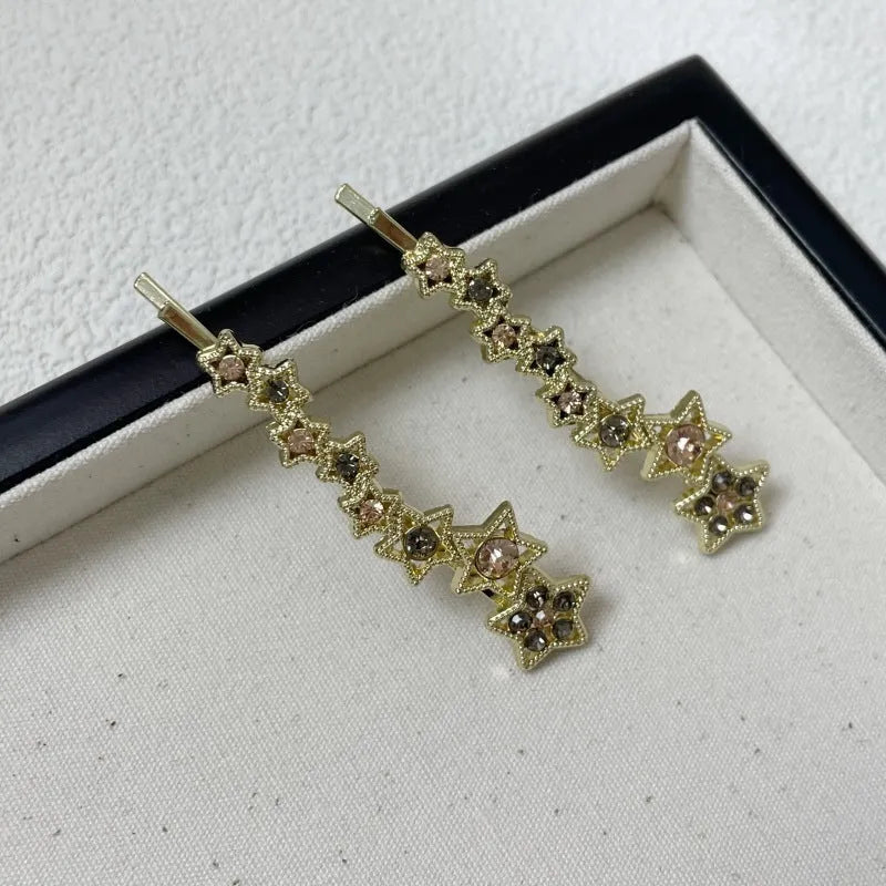 Golden electroplated hair barrette with star decoration and side clip design for bangs