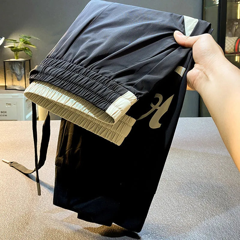 Black men's cropped trousers with elasticated ankle bands in ultra-thin ice silk cotton fabric
