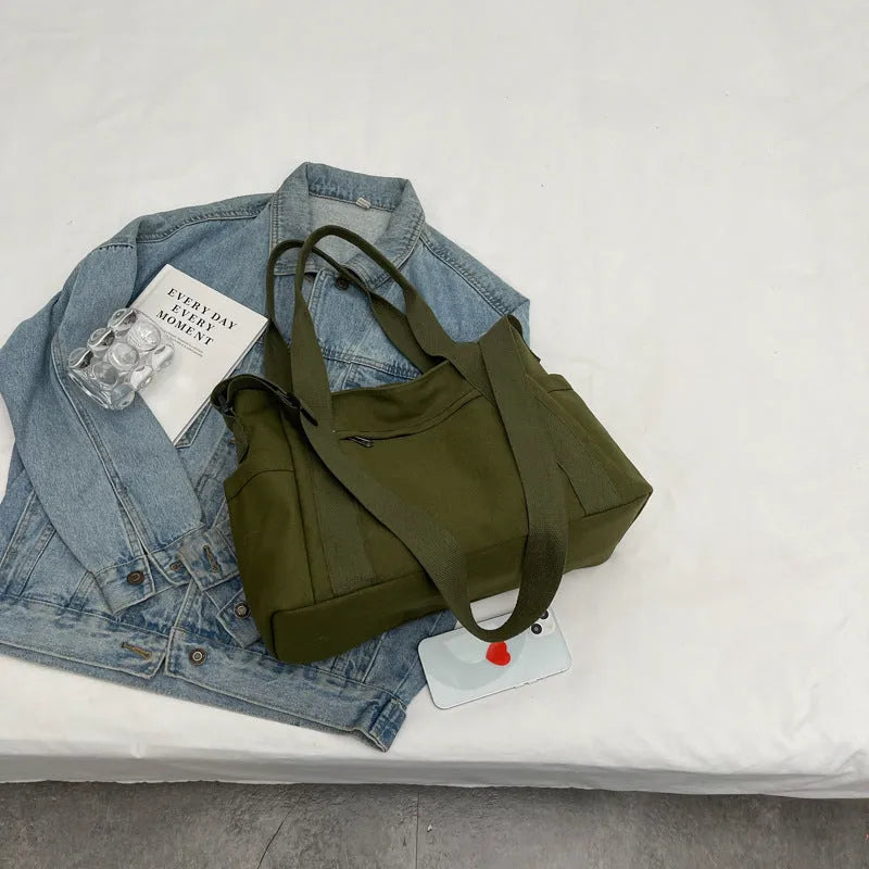 Polyester shoulder bag in solid colour with sandwich pocket and phone compartment