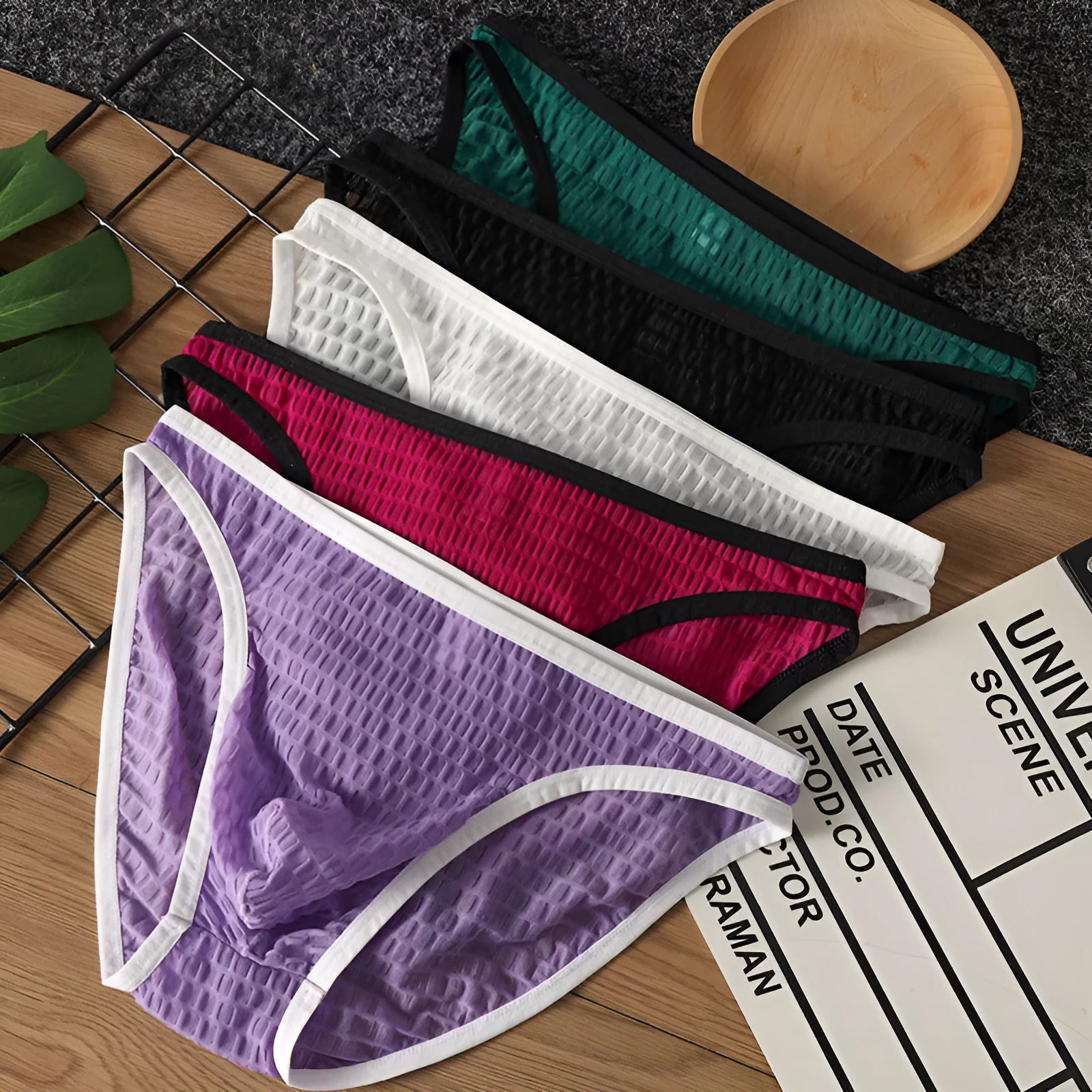 Men's low waist transparent lace underwear shorts in a solid colour on a neutral background.