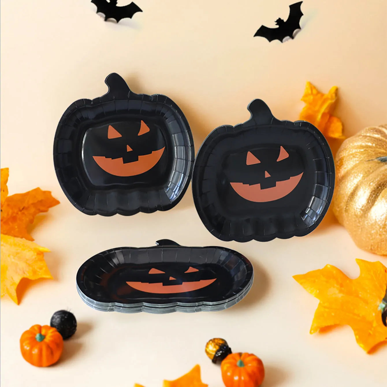 Black disposable paper plate with cute pumpkin design for Halloween, 9 inches in diameter.