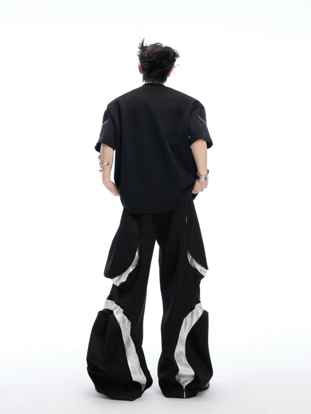 Black cotton blend T-shirt with metal chain detail on padded shoulders, short sleeves, round neck, front view