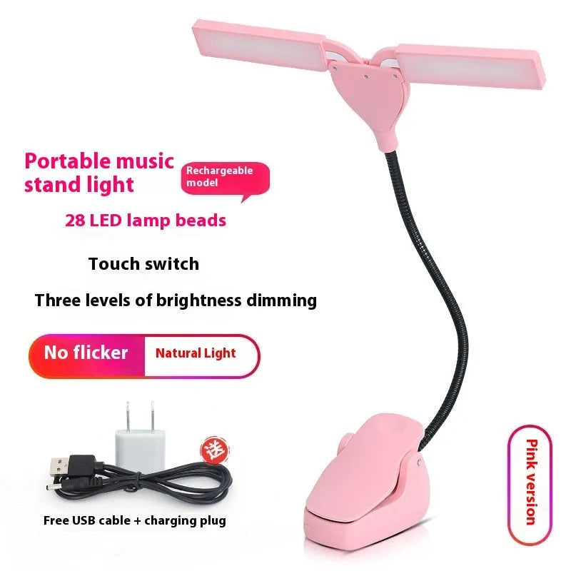 Black rechargeable music stand light with 28 LEDs clipped to metal music stand illuminating sheet music
