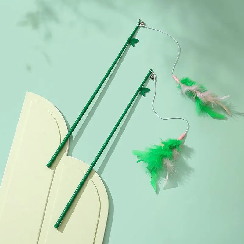 Green cat feather wand toy with bell and feather attachments for interactive play
