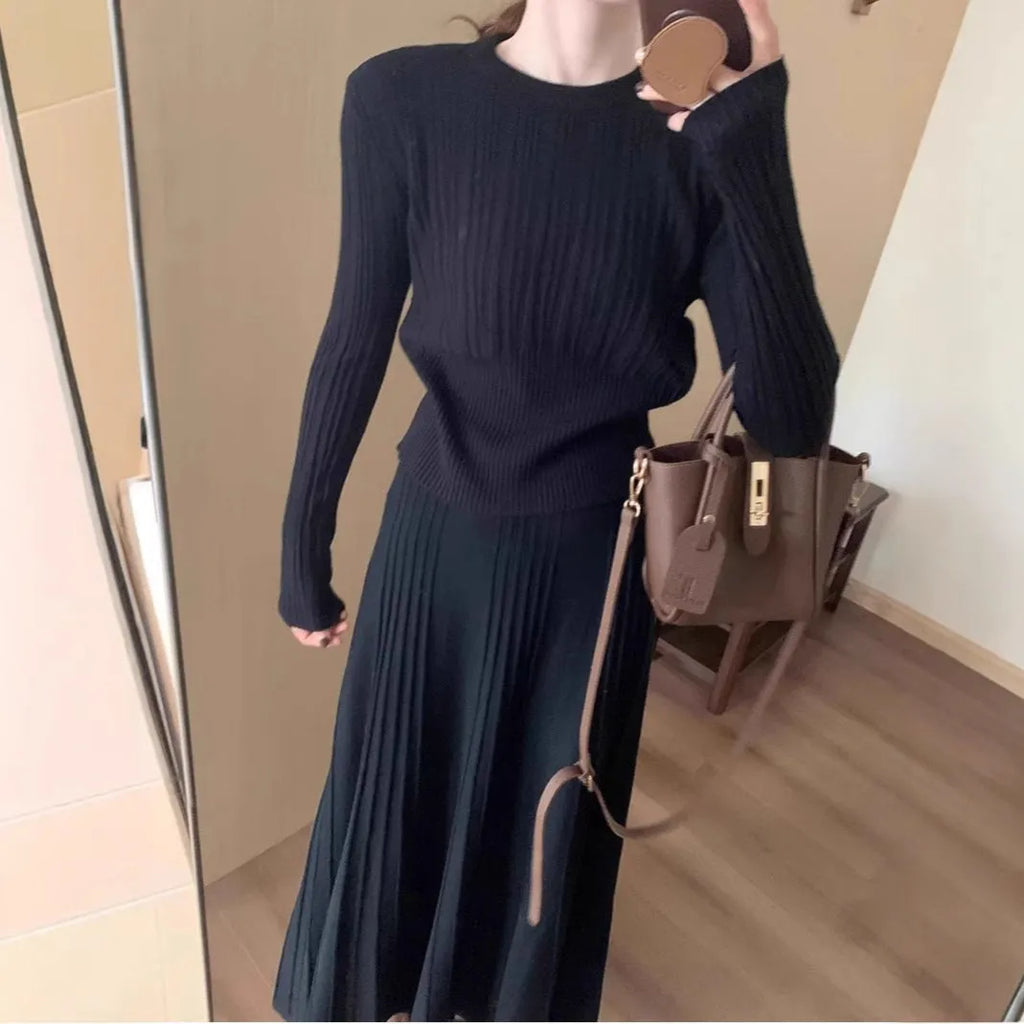 Women's dark grey knitted sweater and skirt suit set with textured 3D pattern and collage stitching.