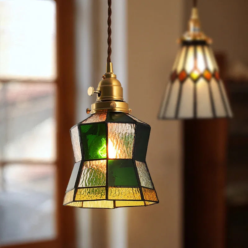 Retro brass and hand-blown glass chandelier with a hemp rope light line hanging from a ceiling.