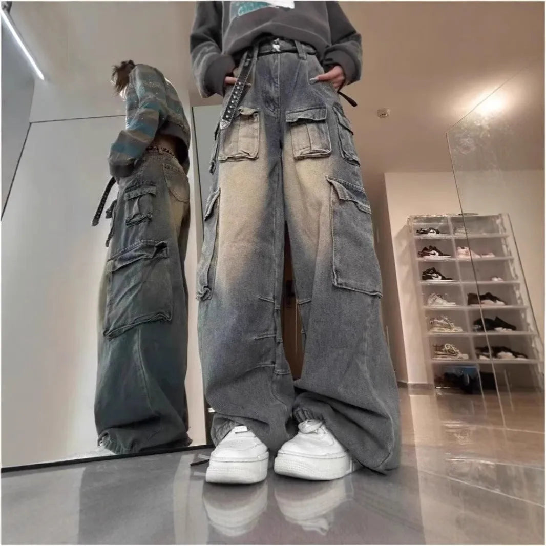 Loose-fit distressed denim jeans with multiple pockets in light blue wash, straight-leg street hipster style