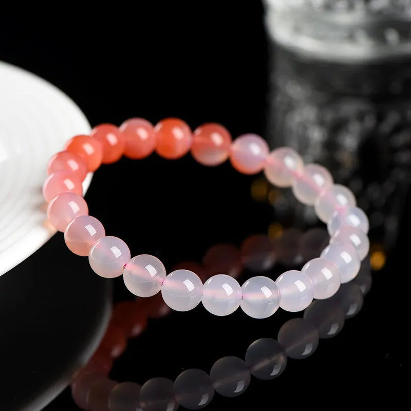 Natural gradient Yanyuan agate beaded bracelet with geometric polished beads on a wrist.