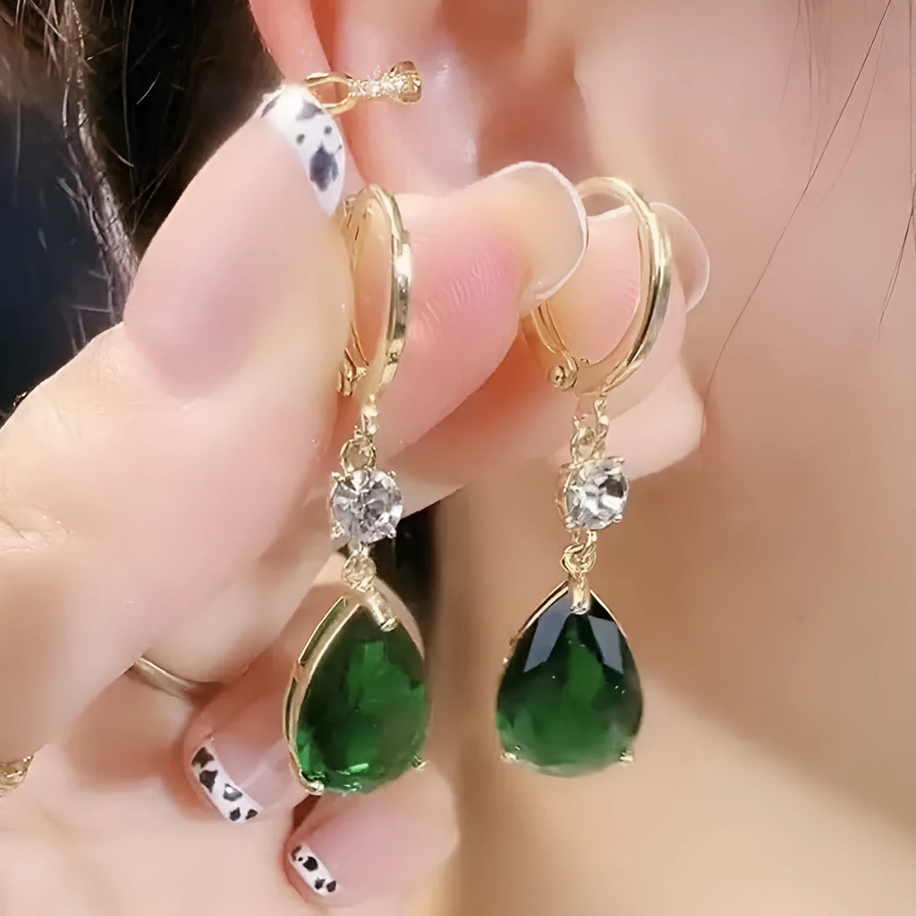 Green geometric teardrop alloy earrings on a white background.