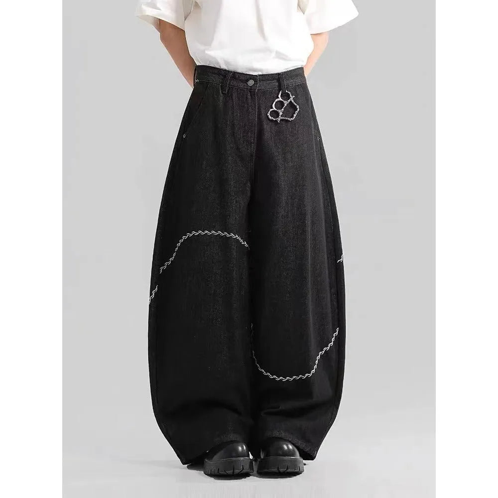 Black straight-leg denim trousers with a mid-waist and zip fly, laid flat.