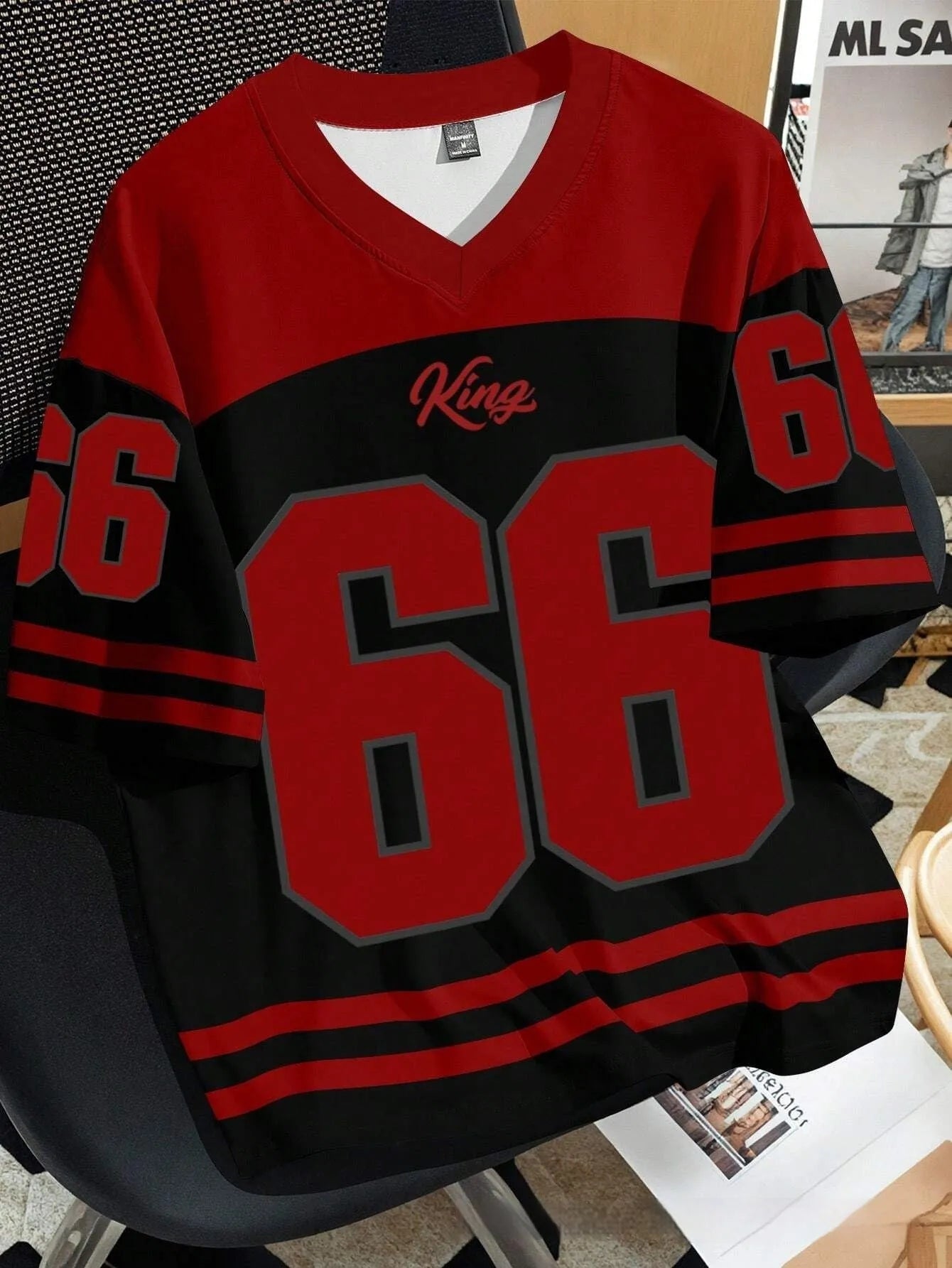 Man wearing a loose fit black t-shirt with a large, colourful 3D printed graphic of Chicago No 23 on the front.