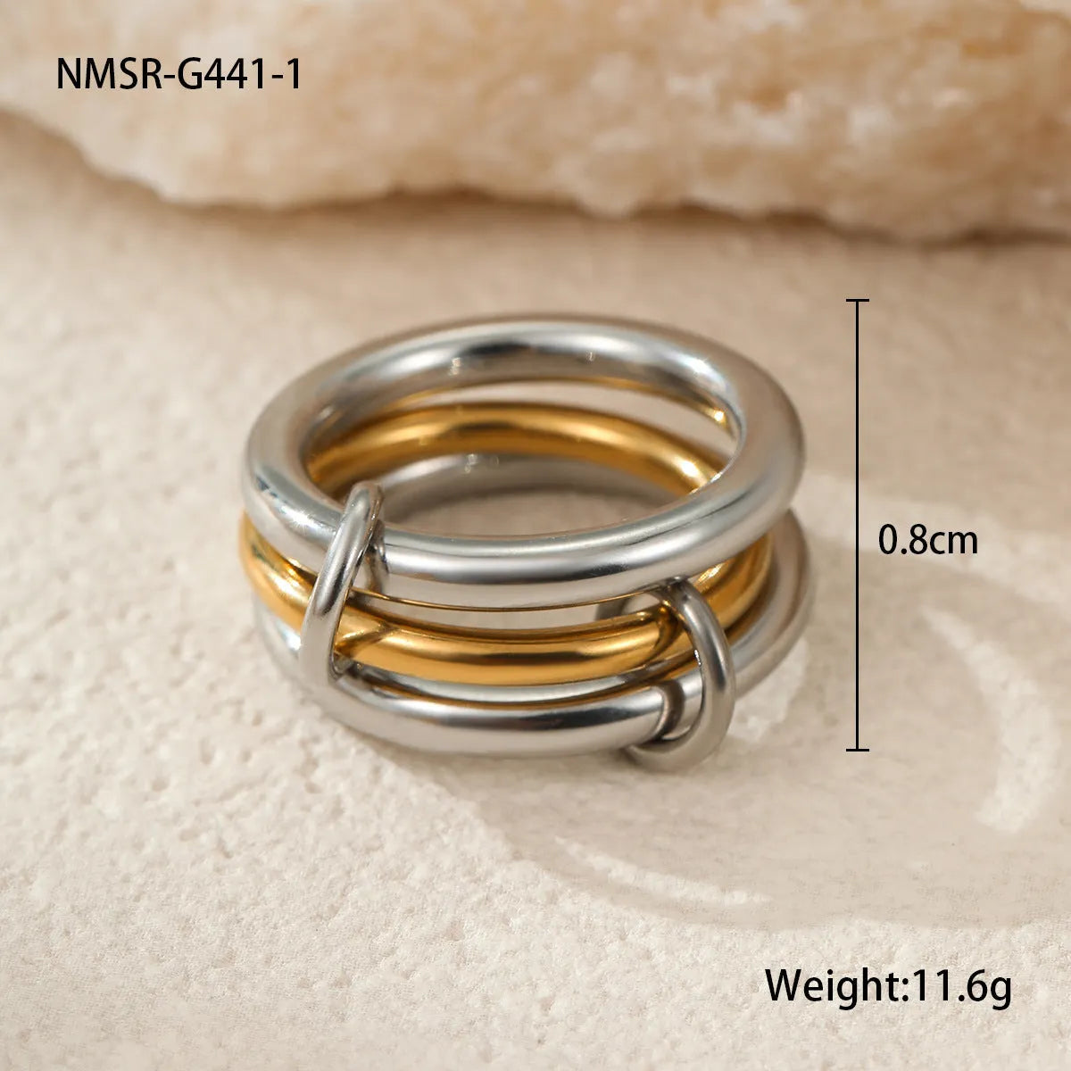Stacked gold plated stainless steel rings showing layered jewellery look on female hand