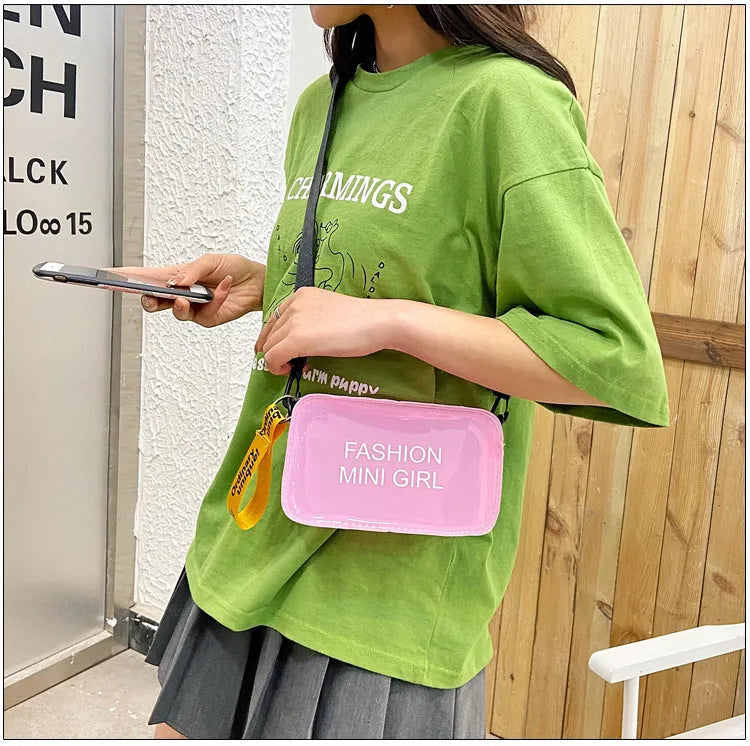 Clear square jelly shoulder bag with adjustable strap in various colours on a white background.