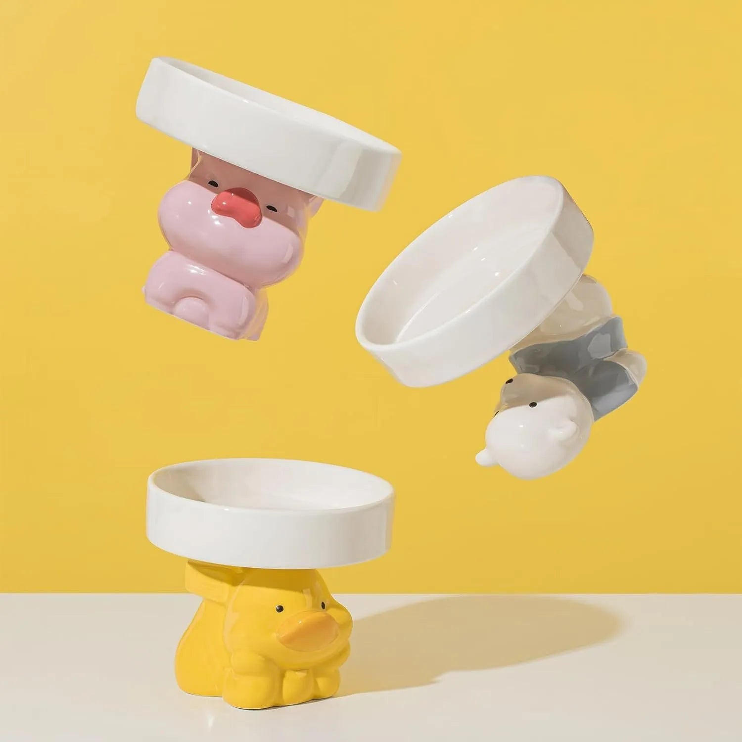 Raised ceramic cat bowl in animal design, showing elevated feeder stand and wide food bowl opening.