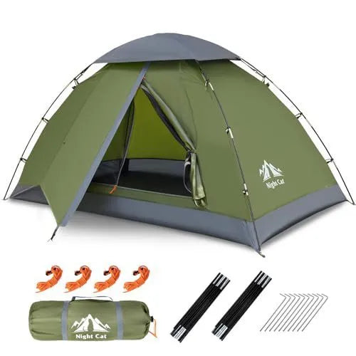Dark green automatic two-person camping tent erected in a field, showing its small house style and compact dimensions.