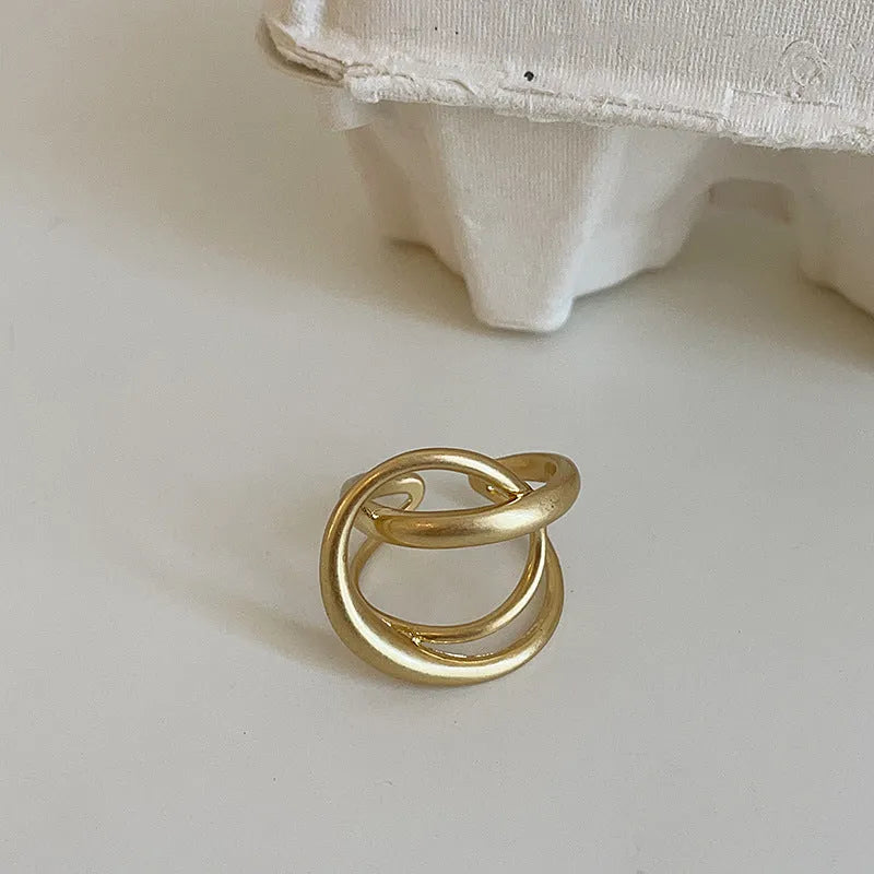 Geometric open ring with three-dimensional interlaced design in matte metal finish