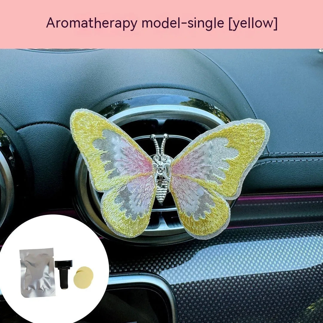 Moving embroidery butterfly decoration on car centre console air vent in pink fabric