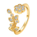 Women's open ring with floral leaf design in gold tone on white background