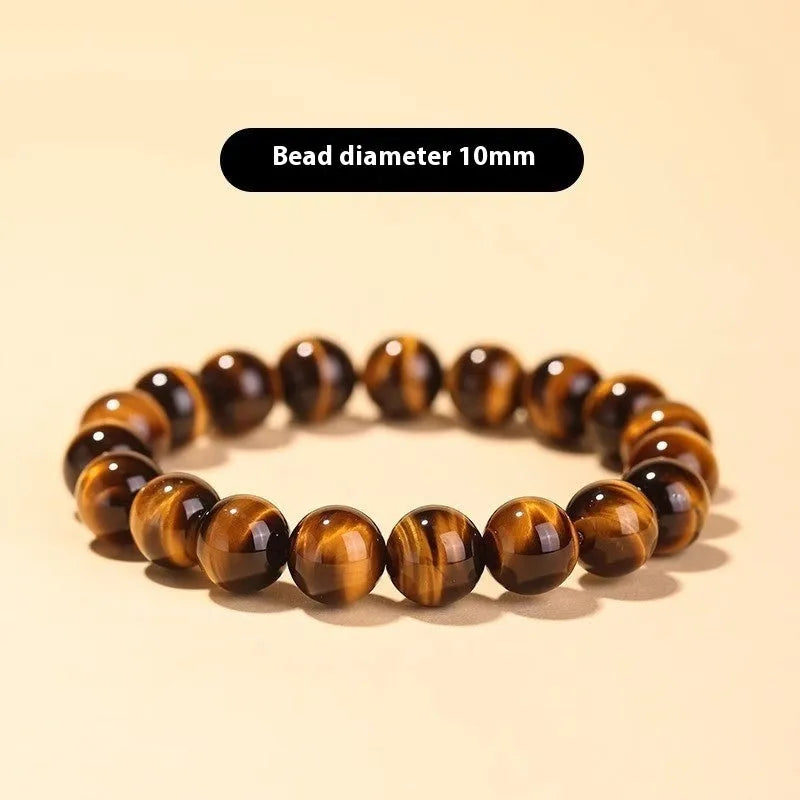 Single Tigereye Dzi bead Buddha rosary bracelet on wrist, showing simple ethnic design.