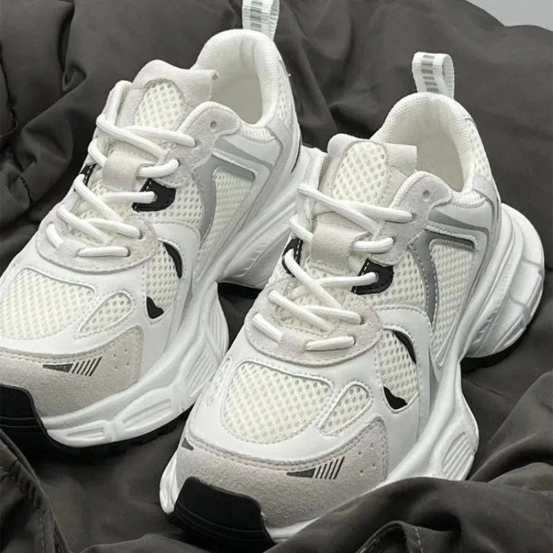 Beige mesh platform shoes with a wedge heel and front lace-up design on a neutral background.