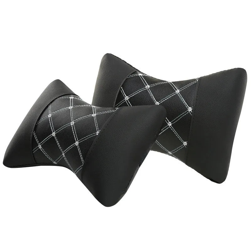 Black leather quilted car headrest neck pillow with diamond pattern and contrast stitching.