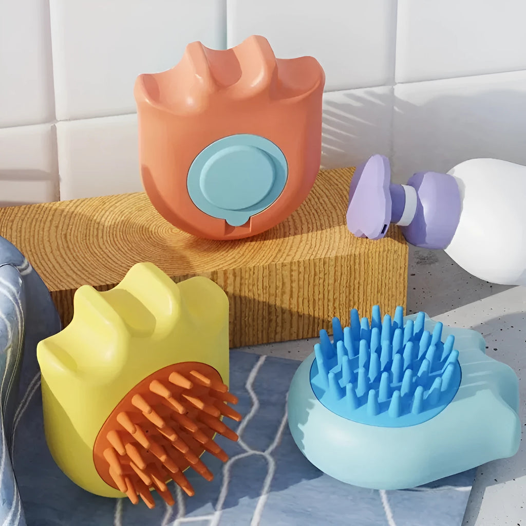 Blue pet bath brush with a shampoo reservoir and soft comb head for washing dogs or cats.