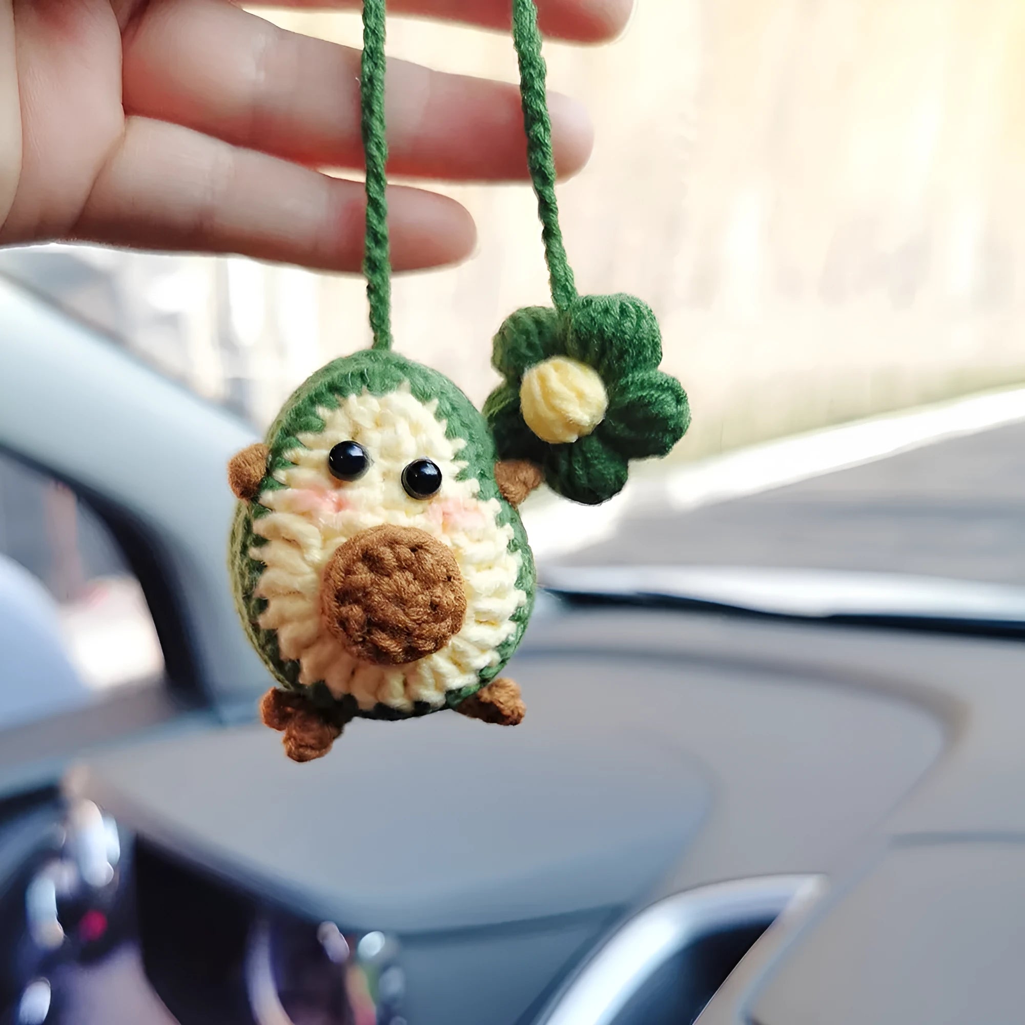 Handmade crocheted rainbow flower car pendant in wool with colourful avocado, pink, and red patterns