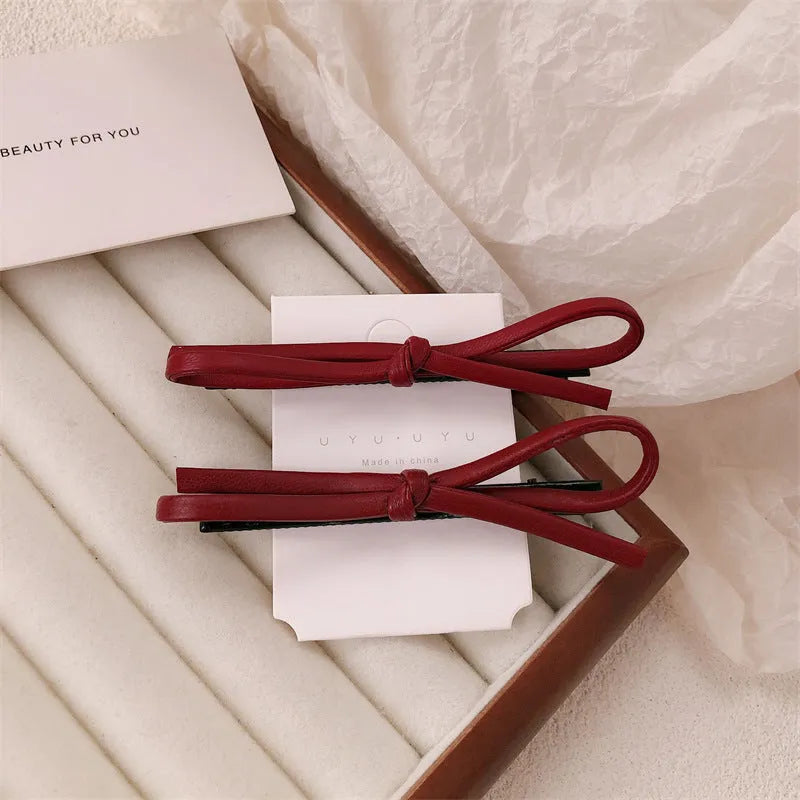 Wine red leather bow hair barrette showing handmade bow design detail