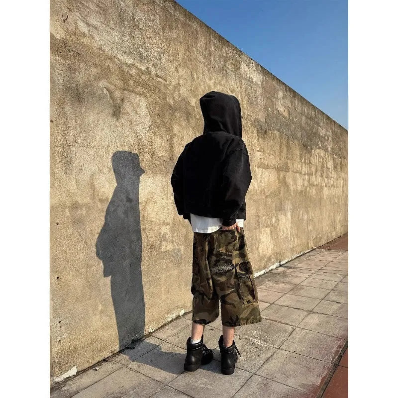Men's camouflage cropped jeans with distressed patch detailing and straight-leg styling