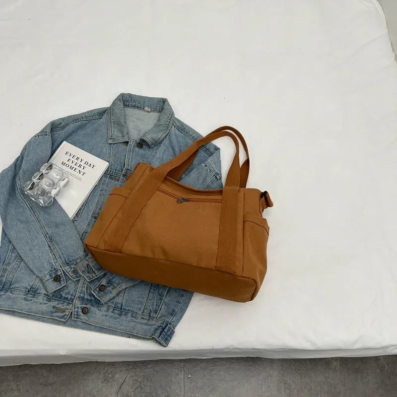 Polyester shoulder bag in solid colour with sandwich pocket and phone compartment