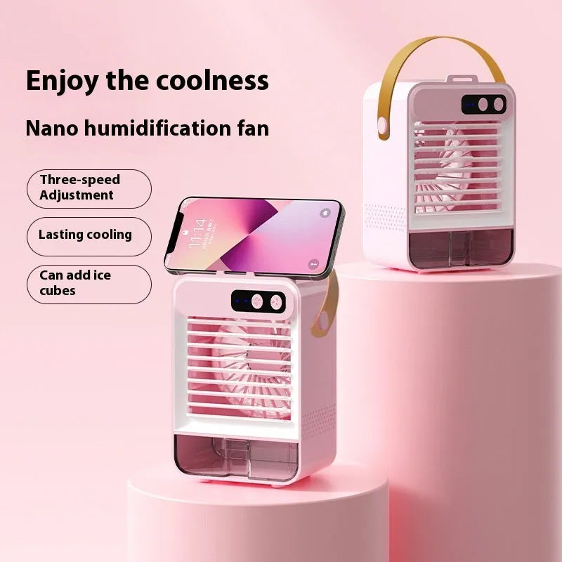 A compact dark green desktop humidifier with USB port on a wooden desk.