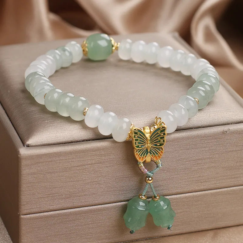 Green crystal women's bracelet with abacus beads, butterfly tassel, rhinestones and pearls