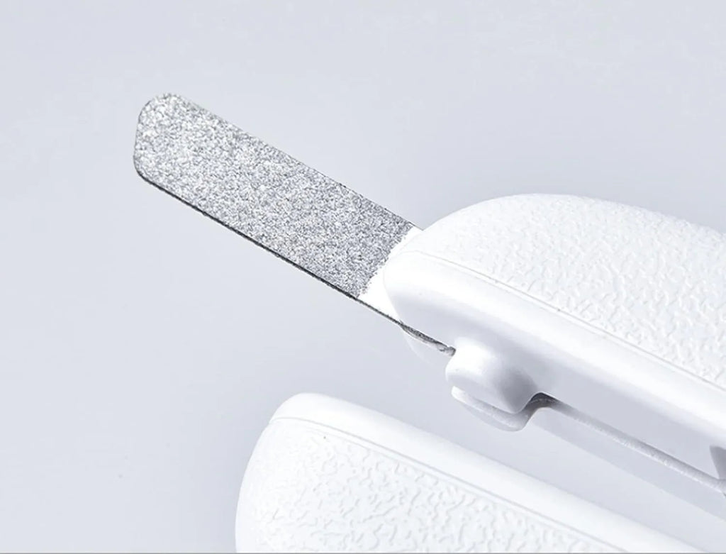White pet nail clippers with LED light and a transparent anti-splash guard, shown with a nail file.