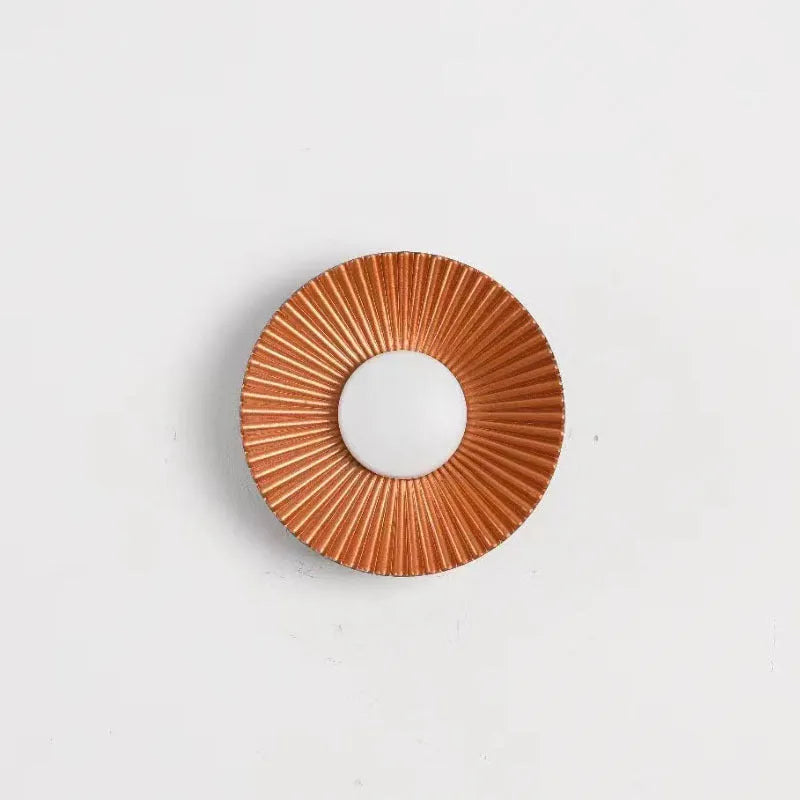 Round aluminium LED wall lamp in a dual-colour finish mounted on a wall.